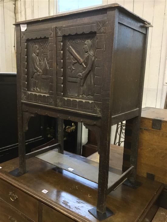 Small carved oak two door cupboard